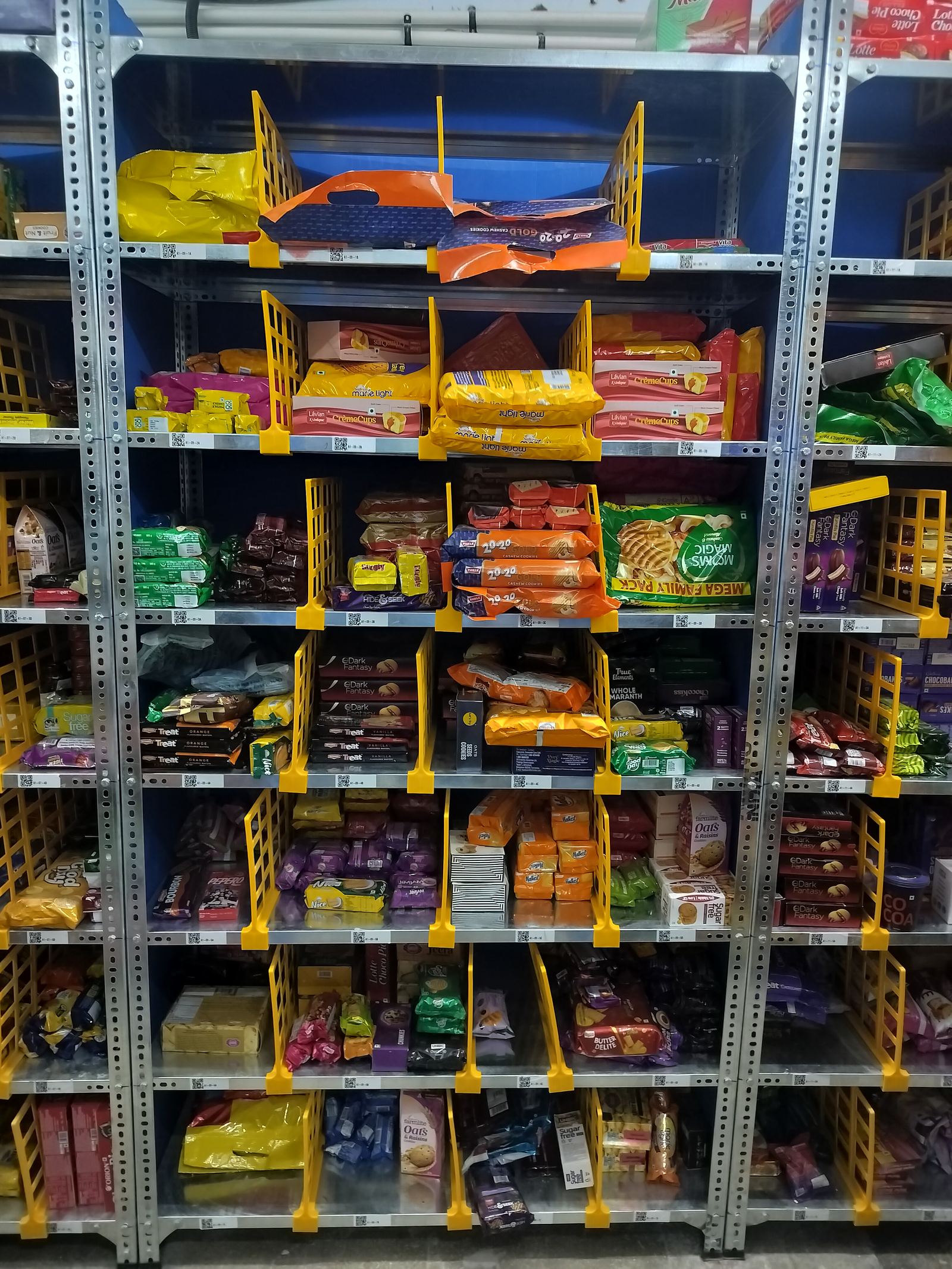 Grocery shelving showing dense SKU mix typical of a quick commerce dark store